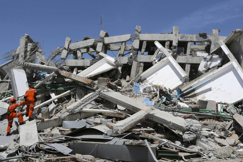 Indonesian rescue team inspect the damage of Roa-Roa Hotel following a massive earthquake and tsunami in Palu, Central Sulawesi, Indonesia, Monday, Oct. 1, 2018. A mass burial of earthquake and tsunami victims was being prepared in a hard-hit city Monday as the need for heavy equipment to dig for survivors of the disaster that struck a central Indonesian island three days ago grows desperate. (AP Photo/Tatan Syuflana)