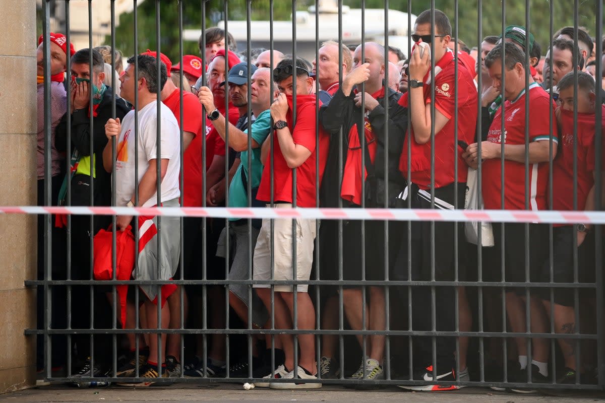 Liverpool fans cover their faces after police deployed tear gas (Getty Images)