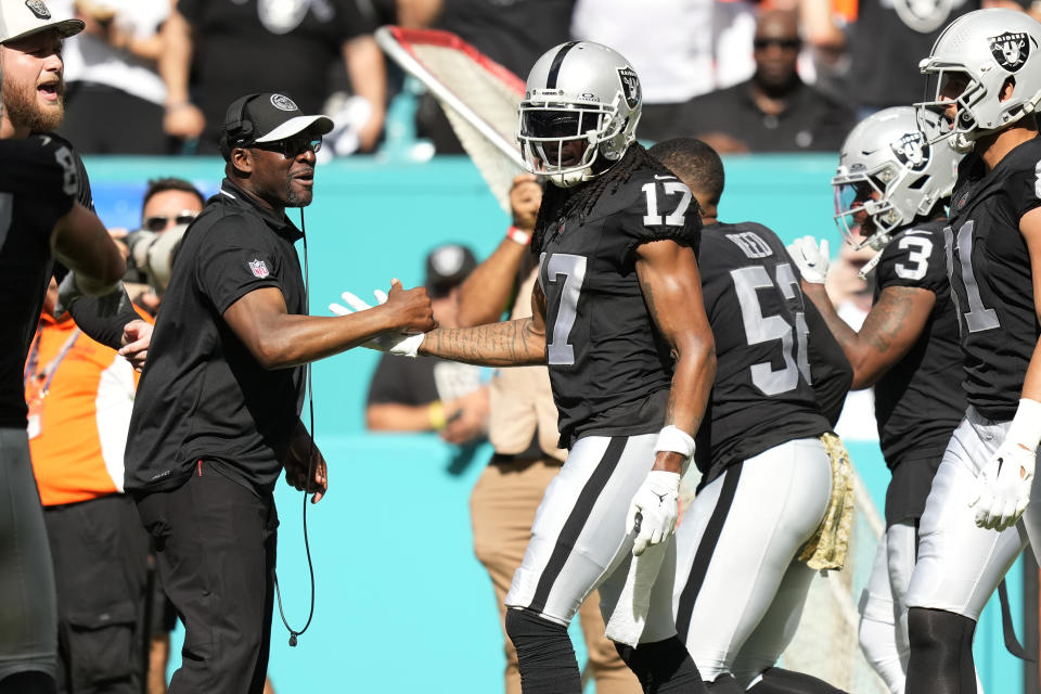 Las Vegas Raiders wide receiver Davante Adams (17) is congratulated after scoring a touchdown during the first half of an NFL football game against the Miami Dolphins, Sunday, Nov. 19, 2023, in Miami Gardens, Fla. (AP Photo/Rebecca Blackwell)