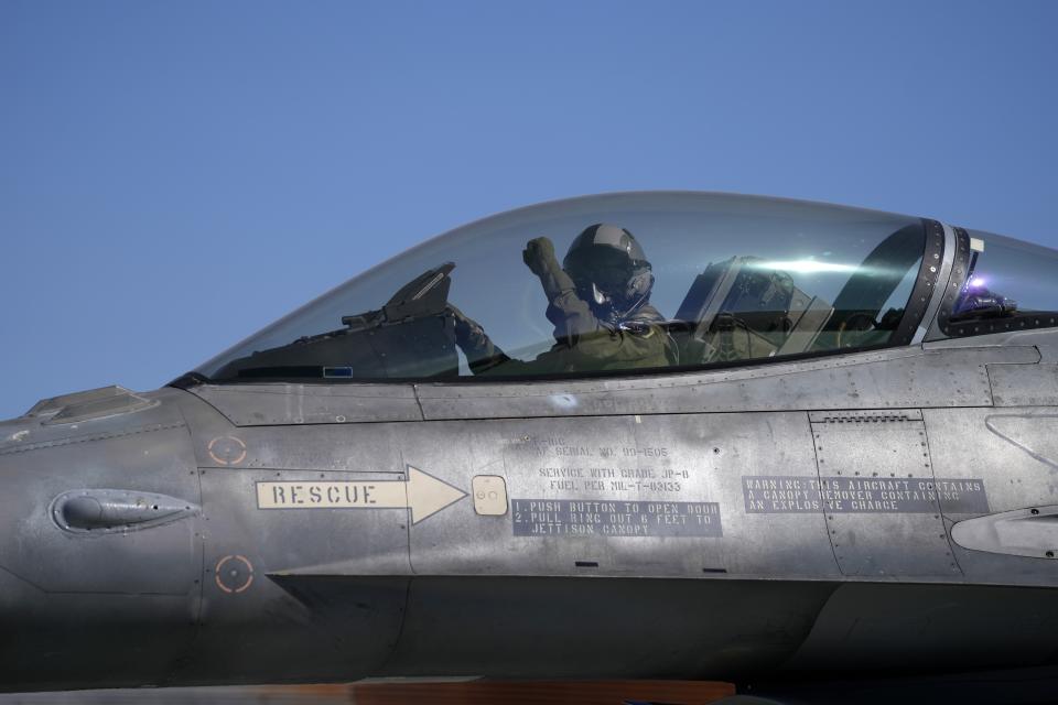 The pilot of a Greek Fighter Jet F-16 Viper salutes as he prepares for takeoff at Tanagra air force base about 74 kilometres (46 miles) north of Athens, Greece, Monday, Sept. 12, 2022. Greece's air force on Monday took delivery of a first pair of upgraded F-16 military jets, under a $1.5 billion program to fully modernize its fighter fleet amid increasing tension with neighboring Turkey. (AP Photo/Thanassis Stavrakis)