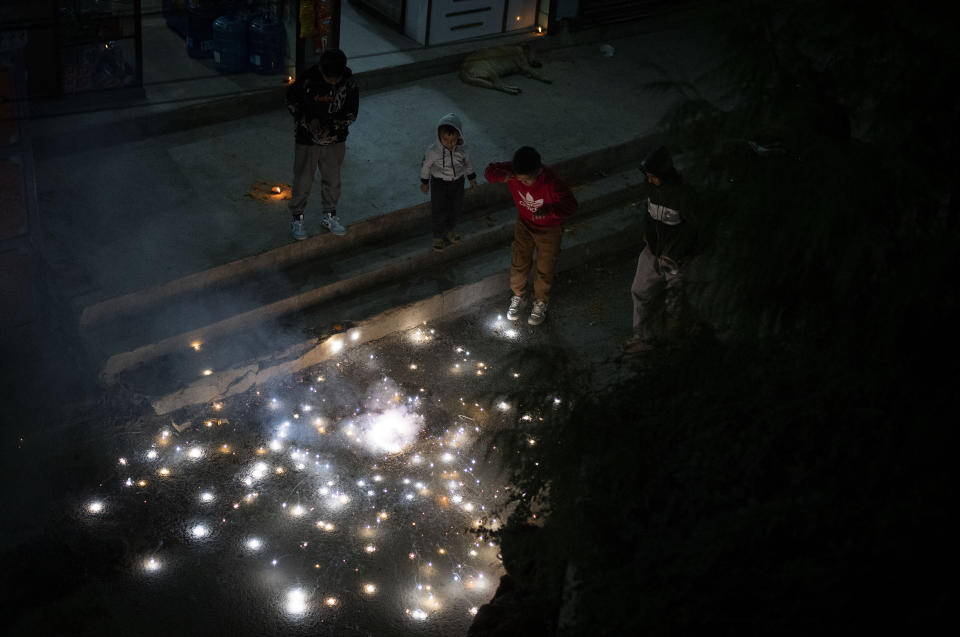 Children light firecrackers during Tihar festival in Kathmandu, Nepal, Monday, Nov. 13, 2023. (AP Photo/Niranjan Shrestha)