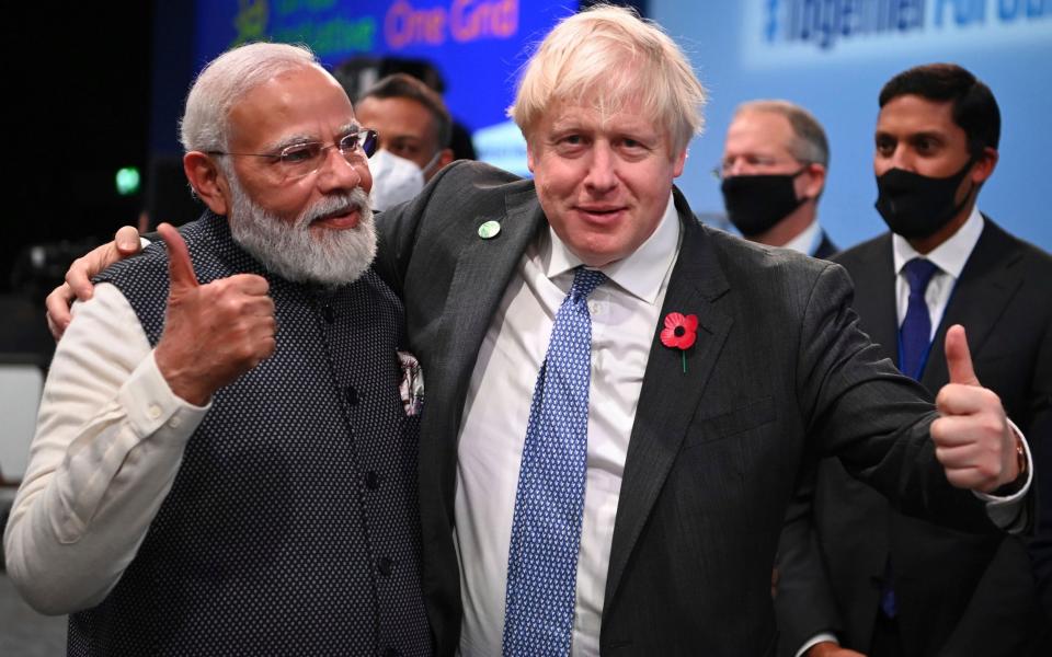 Britain's Prime Minister Boris Johnson, right, and India's Prime Minister Narendra Modi 