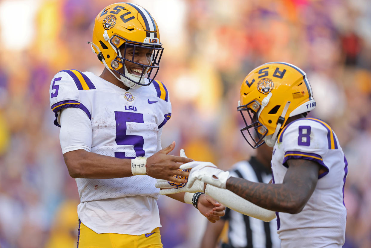 BATON ROUGE, LOUISIANA - OCTOBER 22: Jayden Daniels #5 of the LSU Tigers celebrates a touchdown during the second half of the game against the Mississippi Rebels at Tiger Stadium on October 22, 2022 in Baton Rouge, Louisiana. (Photo by Jonathan Bachman/Getty Images)