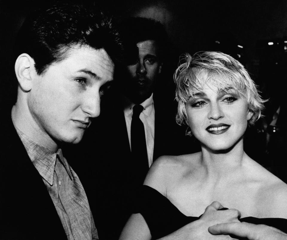 Actor Sean Penn and his wife, singer Madonna, stop to chat with reporters prior to the screening of Penn's new movie, "At Close Range," in Los Angeles Thursday night, April 17, 1986.