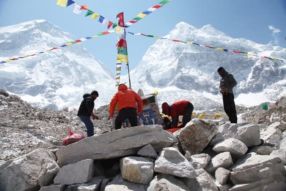 Sherpas, shown on April 13, 2014, at the Everest Base Camp, may be more adapted to breathing at high altitudes, compared with other climbers. Here the Sherpas are building a Budhhist puja altar before their as