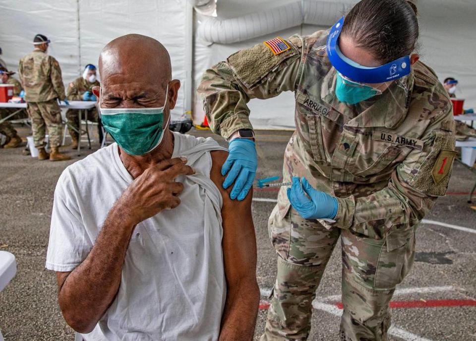 Ralph Morris, 67, is injected with a COVID-19 vaccine by a U.S. Army medic during opening day of the FEMA vaccination site on Miami Dade College’s North Campus on Wednesday, March 3, 2021.