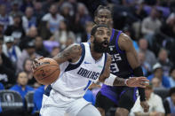 Dallas Mavericks guard Kyrie Irving (11) drives to the basket past Sacramento Kings guard Keon Ellis (23) in the first half of an NBA basketball game in Sacramento, Calif., Tuesday, March 26, 2024. (AP Photo/José Luis Villegas)