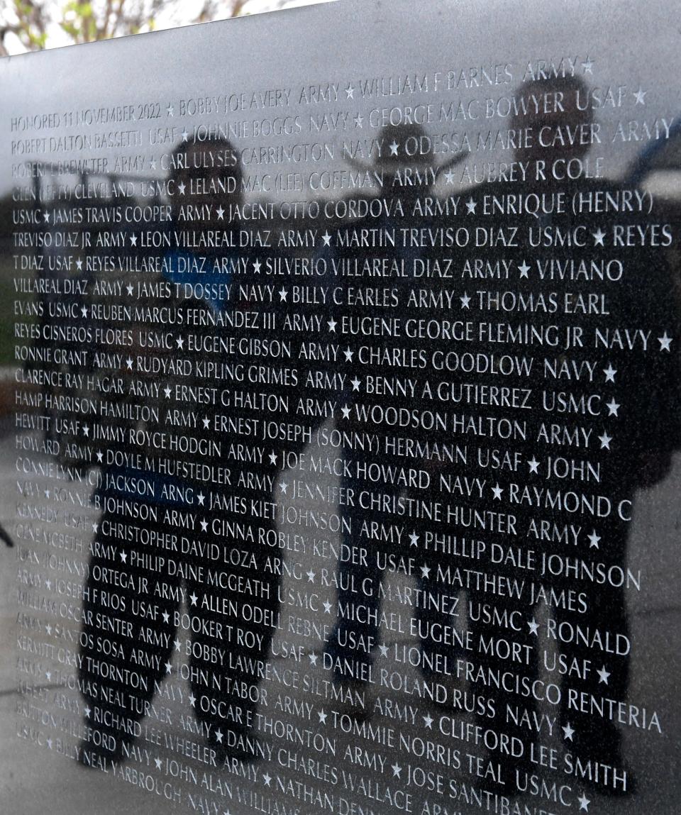 Visitors take in the Veterans Memorial Wall at Dyess Elementary School Friday.