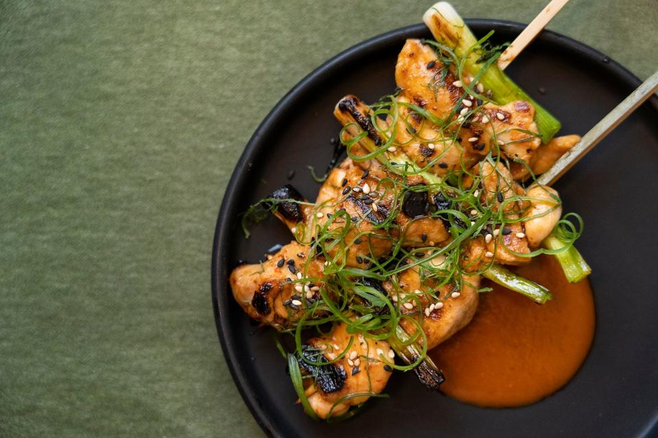 The yakitori section of the menu features chicken thighs with sweet chili and kimchi.