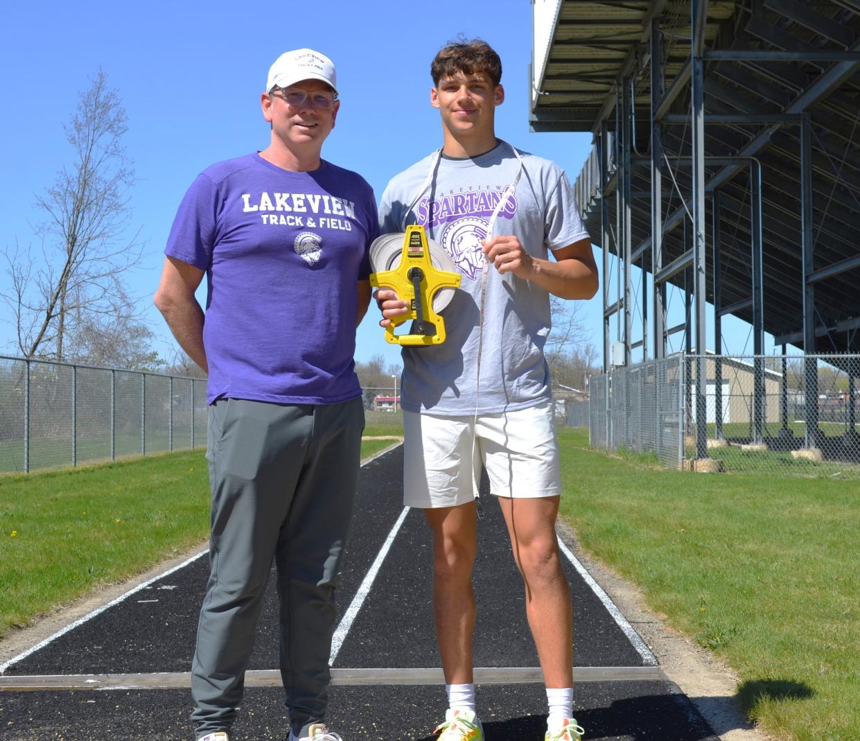 Lakeview senior track standout Davis Barr, right, recently set the school record for the long jump, which was held previously by Spartan assistant coach Jason Moore back in 1992.