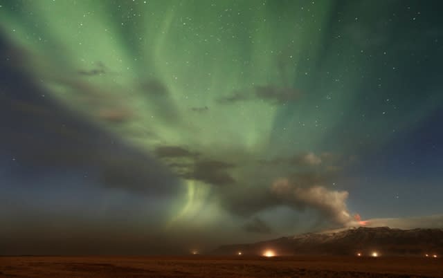 Highly Commended (Earth and Space) 'Volcanic Aurora' by Örvar Atli Þorgeirsson (Iceland) A shimmering aurora, resulting from magnetic activity on the Sun, provides a spectacular background to a dramatic eruption of the Eyjafjallajökull volcano. A dark cloud of ash at ground level can be seen to the left in this photograph, while there is bright red lava at the mouth of the volcano. The eruption caused substantial disruption to international travel in the spring of 2010.