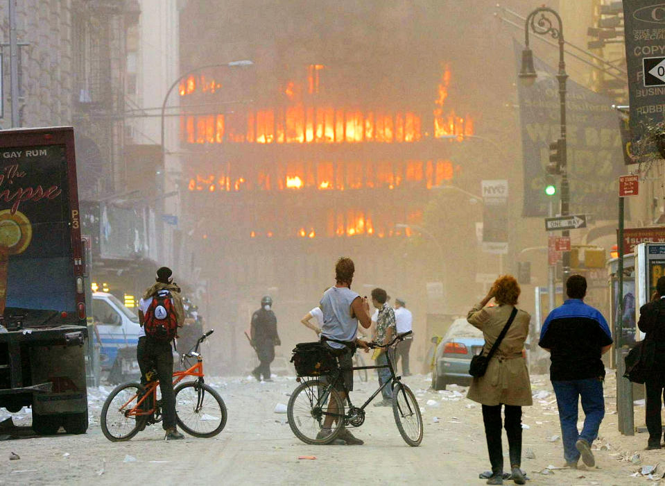 <p>People stop in the street in the area where the World Trade Center buildings collapsed on Sept. 11, 2001, after two airplanes slammed into the twin towers in a terrorist attack. (Photo: Mario Tama/Getty Images) </p>