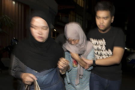 The mother (C) of a missing Trigana Air Service flight attendant leaves the airlines office in Jakarta, Indonesia August 16, 2015 in this photo taken by Antara Foto. REUTERS/Rosa Panggabean/Antara Foto