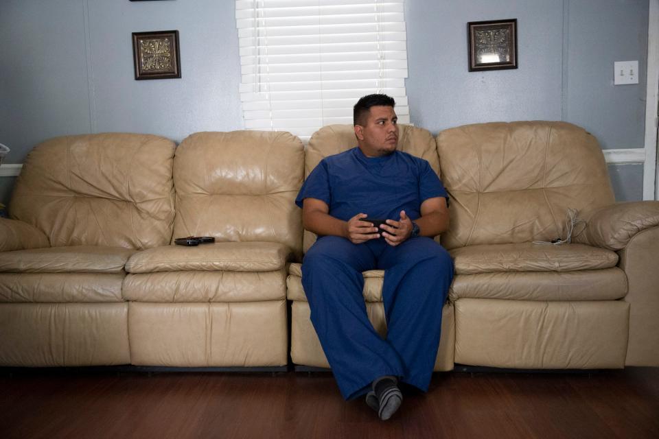 Leo Medina gets ready to begin another long shift at a hospital to help support his family.