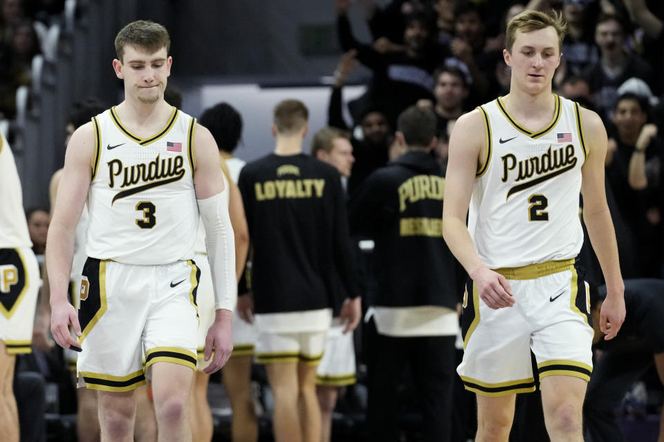 Purdue guards Braden Smith, left, and Fletcher Loyer walk on the court during the second half of an NCAA college basketball game against Northwestern in Evanston, Ill., Sunday, Feb. 12, 2023. (AP Photo/Nam Y. Huh)