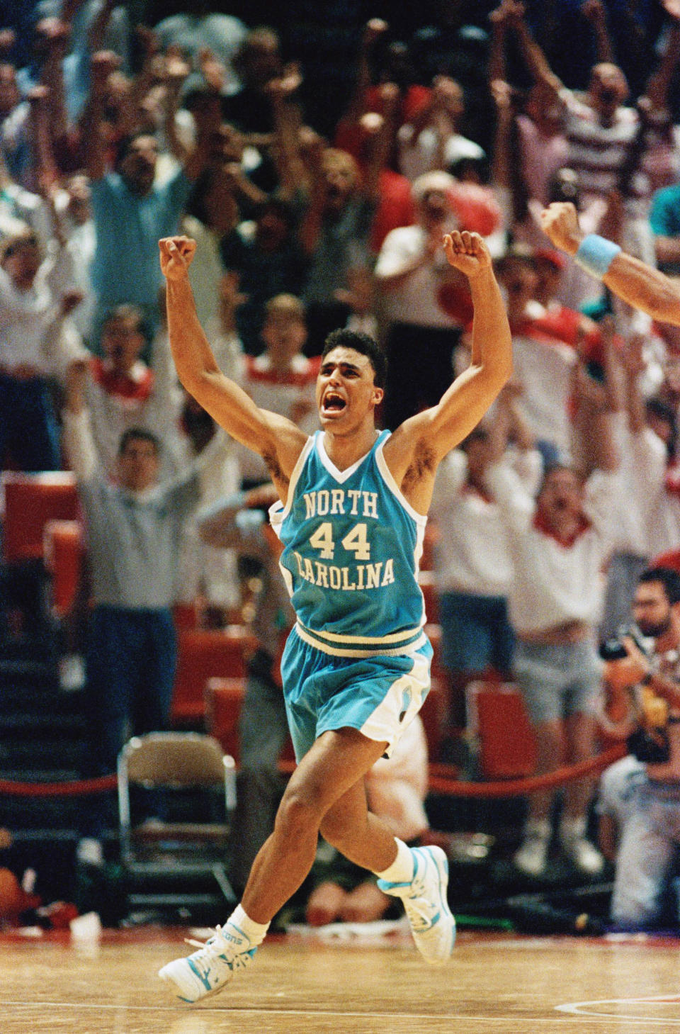 Rick Fox (44) of North Carolina celebrates as he runs across the court after sinking the game-winning basket against Oklahoma as time runs out in the NCAA Midwest sub-regional in Austin, Texas, March 17, 1990. North Carolina won, 79-77. AP Photo/Ron Heflin