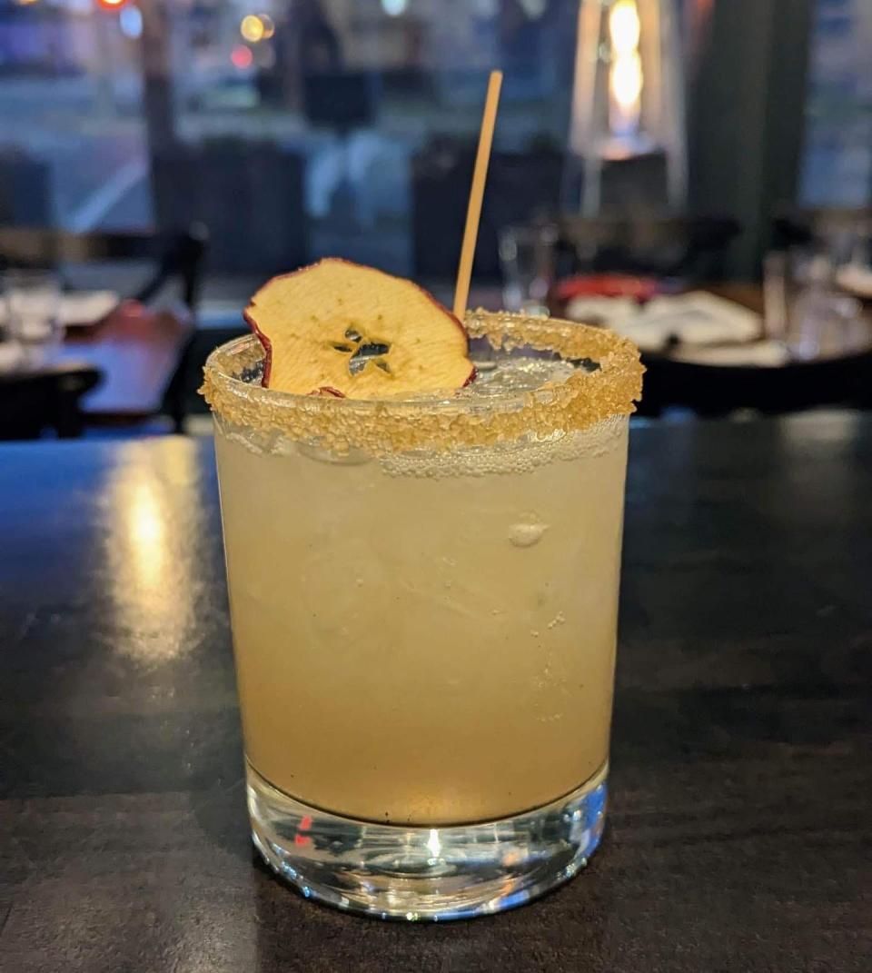 A green apple mule at Square Cut, made with mezcal, ash syrup, apple puree, lime juice, Ale 9 and a crystalized ginger rim.