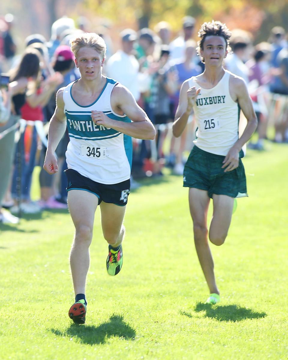 Plymouth South’s Owen Michelin passes Duxbury’s Connor Earle to take thirteenth place during the Patriot League Championship Meet at Hingham High School on Saturday, Oct. 28, 2023. Plymouth South boys would win with 48 points while Marshfield girls would win with 24 points.
