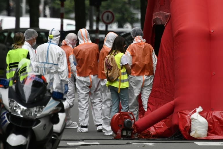 Forensic police worked at the scene of the in shooting in Liege, Belgium, where a gunman shot dead two policewomen with their own weapons before killing a bystander