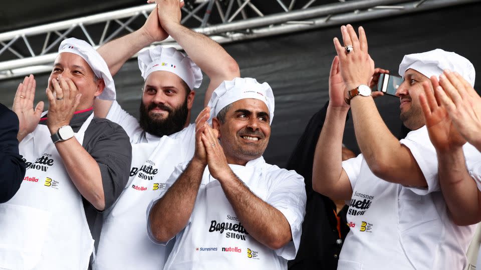 French bakers react after breaking the record for the longest bagette in the world measuring 140.53 meters long. - Stephanie Lecocq/Reuters