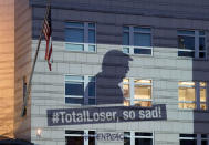 <p>A Greenpeace banner showing President Donald Trump and the slogan ‘#TotalLoser, so sad!’ is projected onto the facade of the U.S. Embassy in Berlin, Germany, Friday, June 2, 2017. (AP Photo/Michael Sohn) </p>