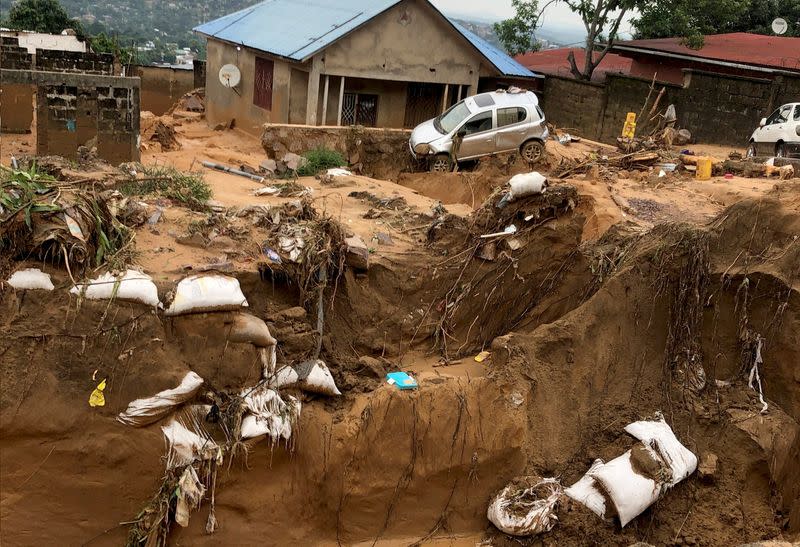 A car is seen stuck after heavy rains caused floods and landslides, on the outskirts of Kinshasa,