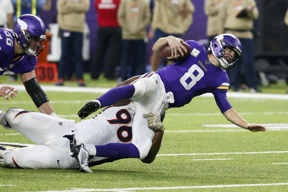 Minnesota Vikings quarterback Kirk Cousins (8) is sacked by Denver Broncos defensive tackle Shelby Harris (96) during the second half of an NFL football game, Sunday, Nov. 17, 2019, in Minneapolis. (AP Photo/Bruce Kluckhohn)