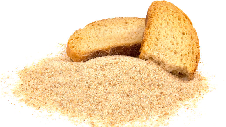 Bread slices and breadcrumbs on a white background