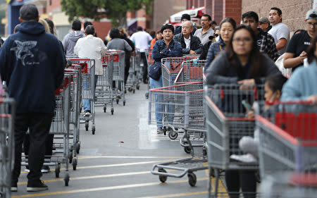 GLENDALE, CALIFORNIA - MARCH 12: People wait in line to enter a Costco Wholesale store before it opened in the morning on March 12, 2020 in Glendale, California. Once the store opened, the line moved smoothly and most people were able to enter to make purchases within about 15 minutes. Some Americans are stocking up on food, toilet paper, water and other items the day after the World Health Organization (WHO) declared Coronavirus (COVID-19) a pandemic.  (Photo by Mario Tama/Getty Images)