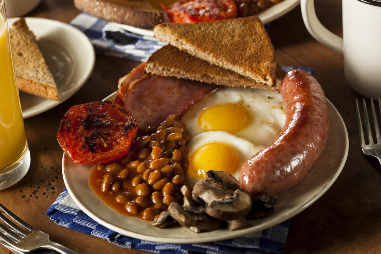 Traditional Full English Breakfast with Eggs, Bacon, Sausage, and Baked Beans