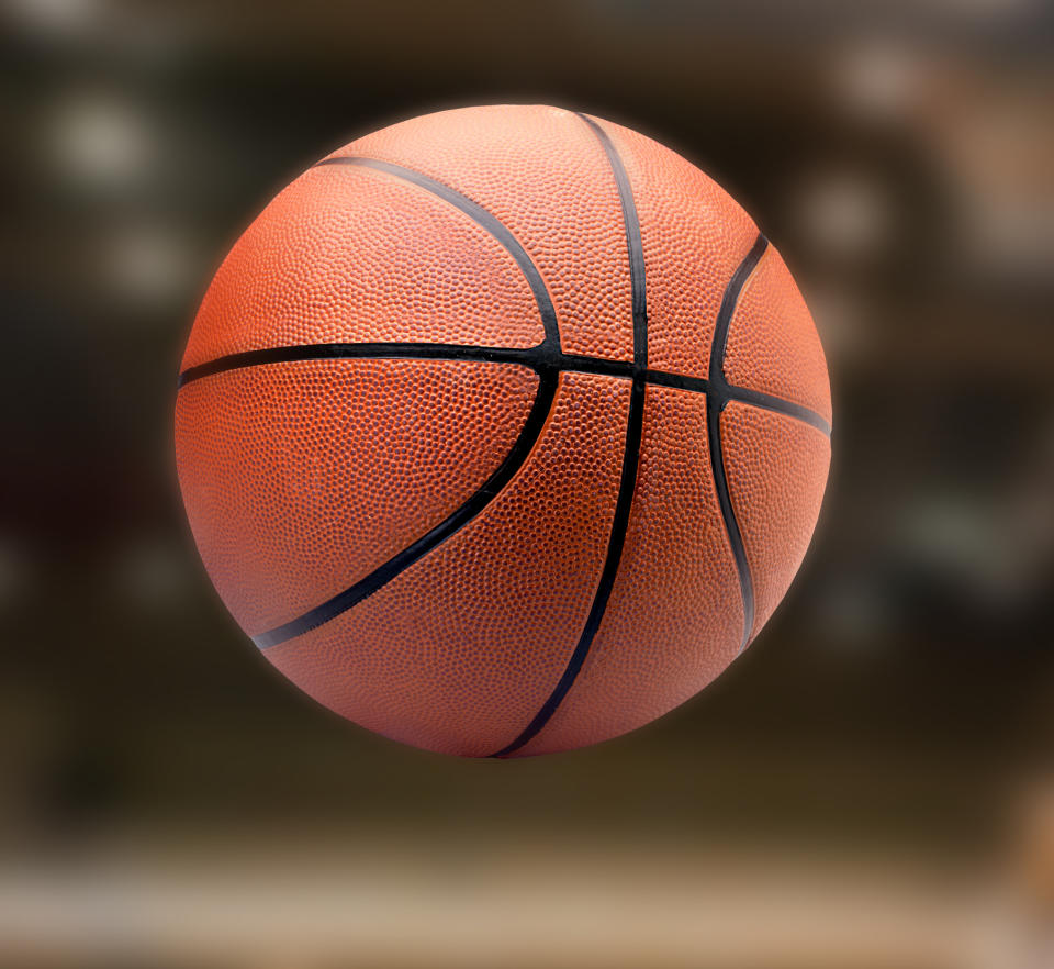 Close-up of an orange basketball against a blurred background