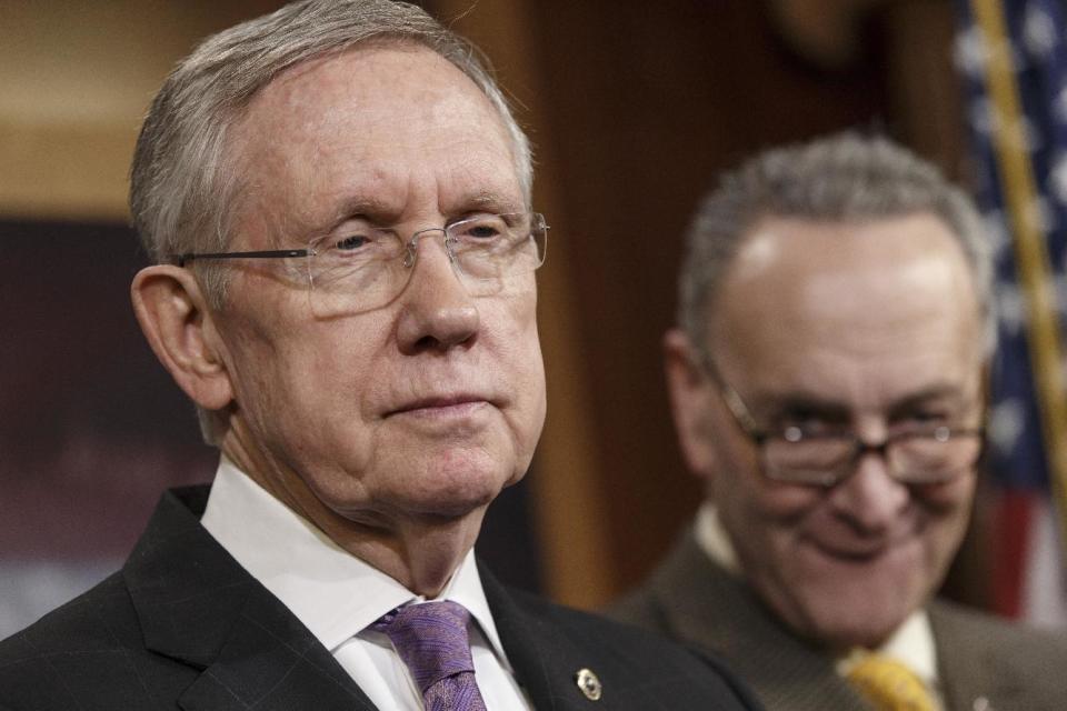 FILE -In this Dec. 19, 2013, file photo, Senate Majority Leader Harry Reid of Nev., left, accompanied by Sen. Charles Schumer, D-N.Y., listens during a news conference on Capitol Hill in Washington. Congress returns to work on Jan. 6, 2014, with election-year politics certain to shape an already limited agenda. (AP Photo/J. Scott Applewhite, File)