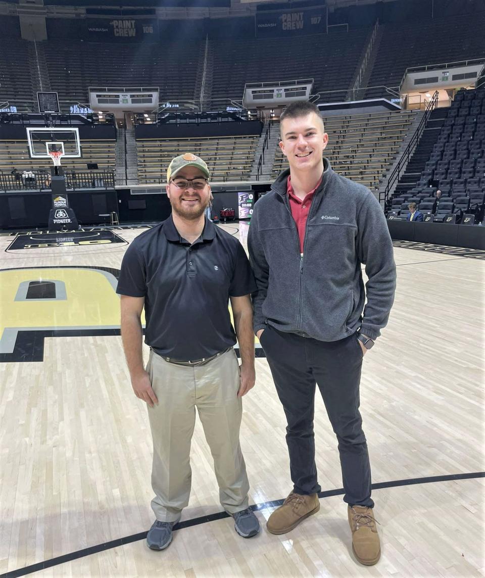 Palladium-Item reporter Zach Piatt (left) takes a picture with friend Stephan Walker (right) on the Mackey Arena court after the Purdue-Indiana men's basketball game Feb. 25, 2023.