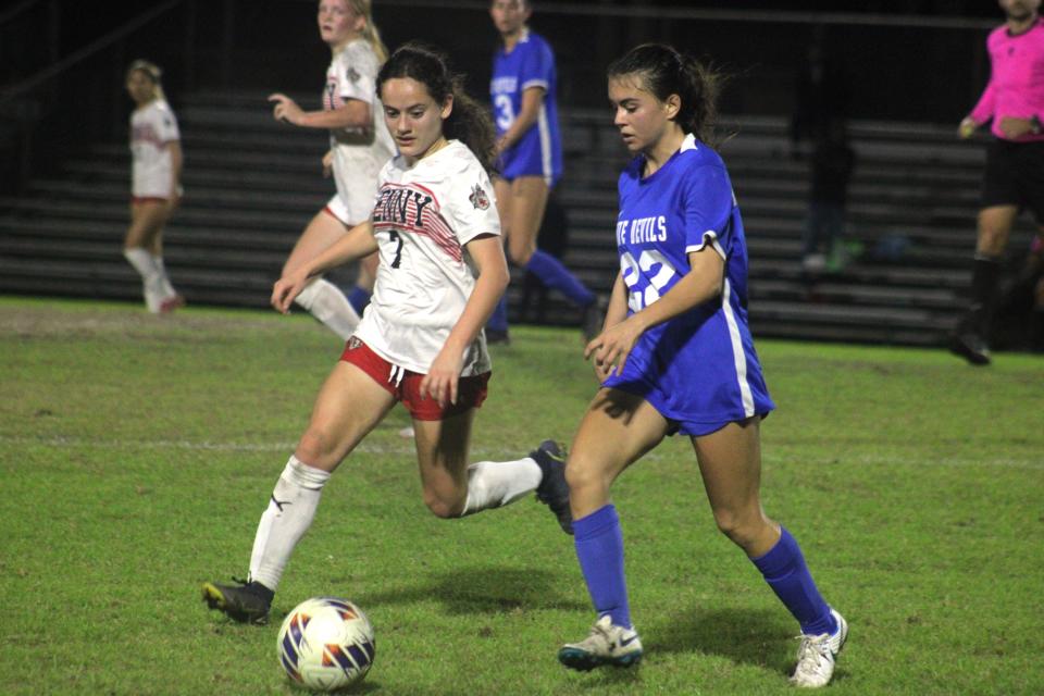 Stanton midfielder Tea Tola (22) and Bishop Kenny forward Isabel Alejandro-Blanco (7) challenge for possession during an FHSAA Region 1-4A high school girls soccer semifinal on February 9, 2024. [Clayton Freeman/Florida Times-Union]