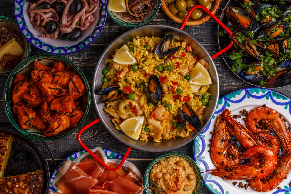 Table of Spanish food including Paella and fresh seafood. Source: Getty Images