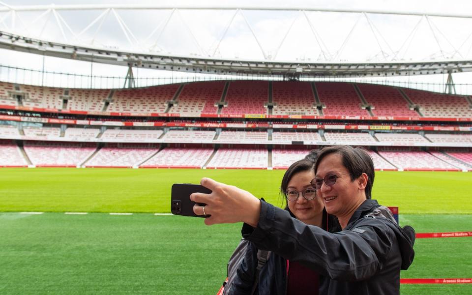 People enjoy a free stadium tour after receiving their Covid vaccines at Arsenal's Emirates Stadium - Dominic Lipinski/PA Wire