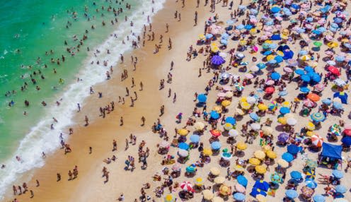 <span class="caption">A crowded Copacabana Beach in Rio de Janeiro, Brazil.</span> <span class="attribution"><a class="link " href="https://www.shutterstock.com/image-photo/rio-de-janeiro-brazil-aerial-view-1293099220" rel="nofollow noopener" target="_blank" data-ylk="slk:R.M. Nunes/Shutterstock;elm:context_link;itc:0;sec:content-canvas">R.M. Nunes/Shutterstock</a></span>