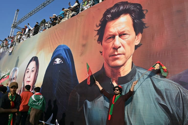 Supporters of the Pakistan Tehreek-e-Insaf (PTI) party of former prime minister Imran Khan (depicted in mural), take part in a rally on the outskirts of Islamabad on September 8, 2024 (Farooq NAEEM)