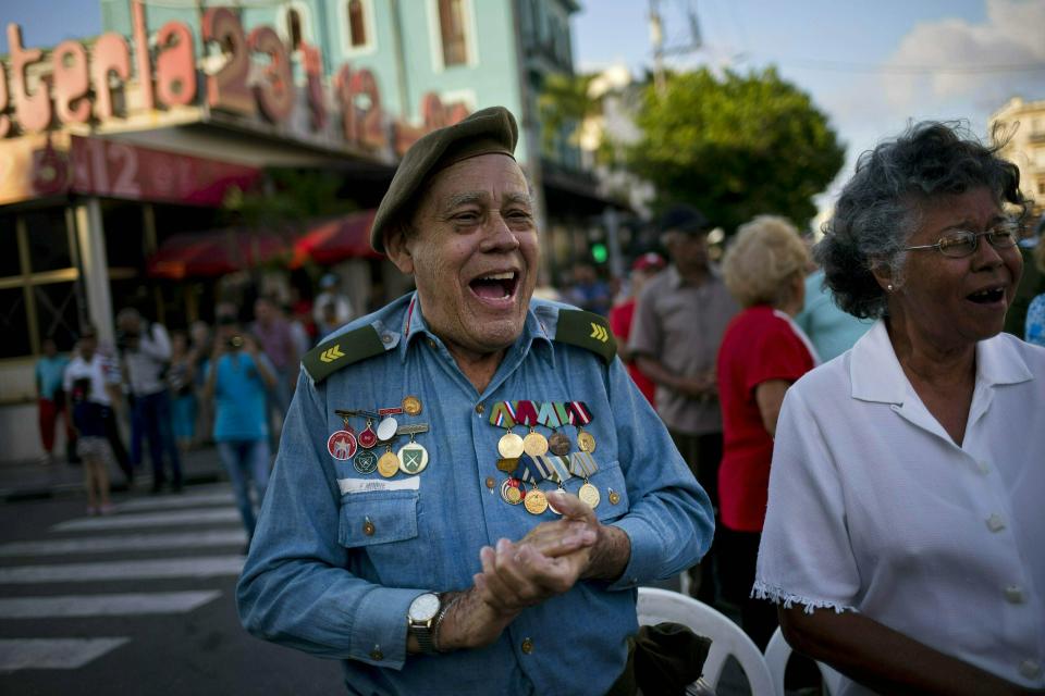 In this April 16, 2019 photo, Edwin Moore, a veteran of the U.S. Bay of Pigs invasion, sings during an event commemorating the 58th anniversary of Fidel Castro's declaration that his revolution in the 1950s was a socialist one, in Havana, Cuba. Reaction to news that the Trump administration plans to tighten sanctions against Cuba prompted worry, defiance and warnings on Tuesday, with Bay of Pigs veterans dismissing U.S. pressure. (AP Photo/Ramon Espinosa)