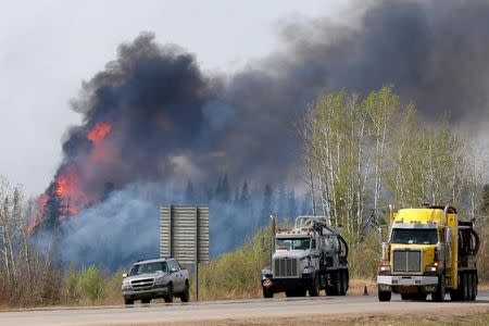 A wildfire burns near Highway 63 south of Fort McMurray, Alberta, Canada, May 8, 2016. REUTERS/Chris Wattie