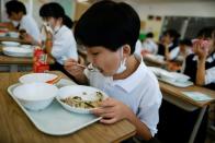 A student eats school lunch at Senju Aoba Junior High School in Tokyo