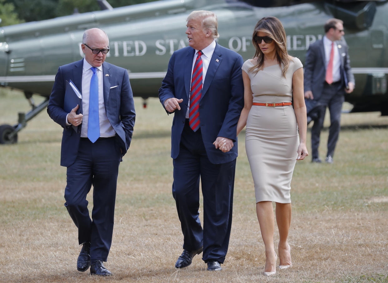 President Donald Trump, center, and first lady Melania Trump, right, walk with Woody Johnson, left, United States Ambassador to the United Kingdom in 2018. (AP Photo/Pablo Martinez Monsivais)