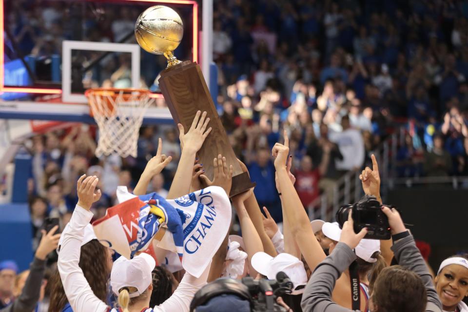 Kansas players hoist up the 2023 Postseason WNIT championship trophy after defeating Columbia 66-59 on April 1 inside Allen Fieldhouse Saturday.