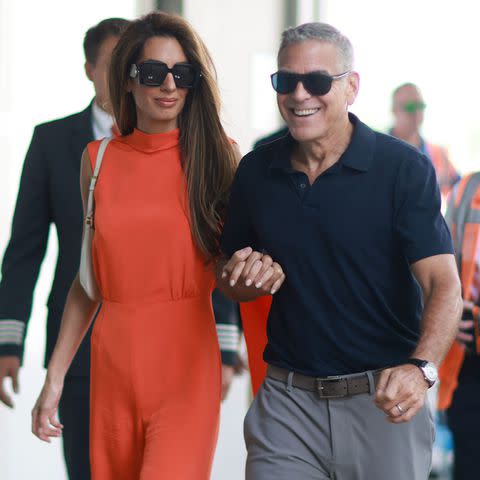 <p>SplashNews</p> Amal and George Clooney