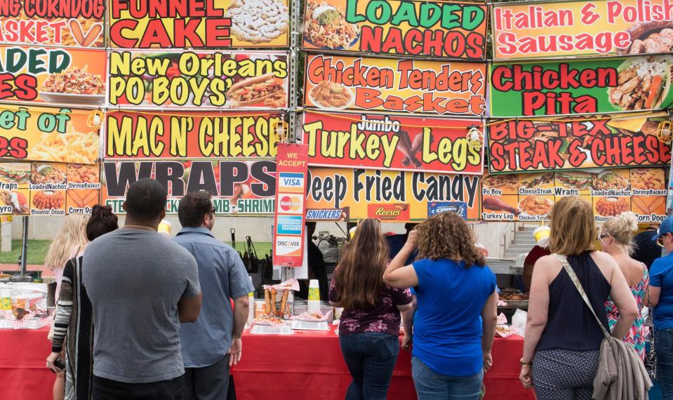 Festival goers wait in line for food during the 2019 ShrinersFest Friday, June 21, 2019.