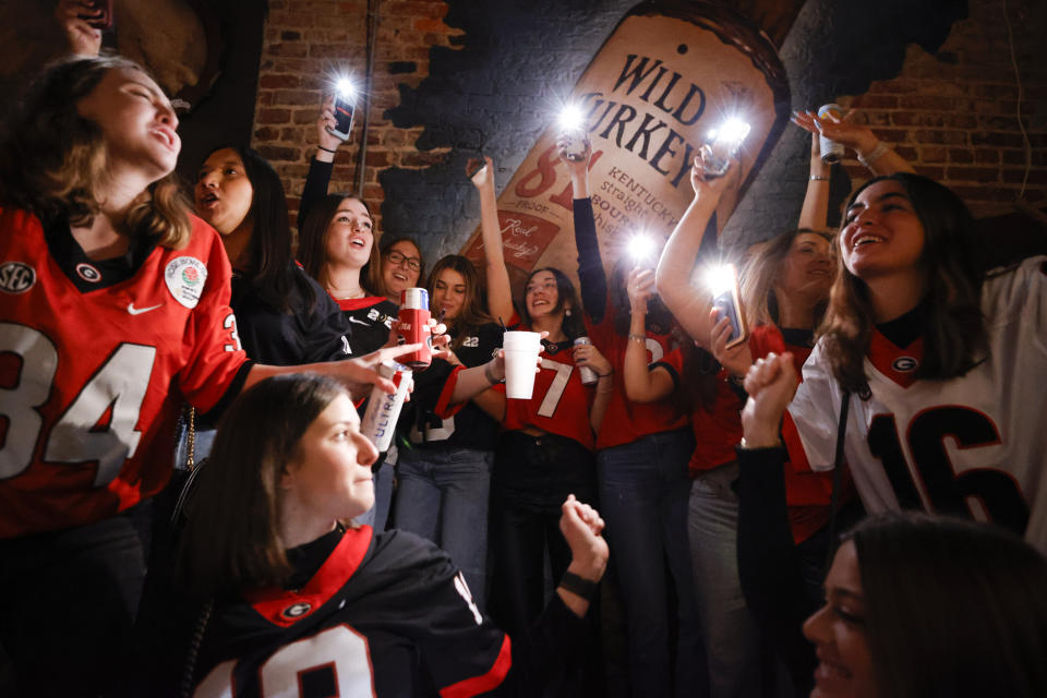 Georgia students celebrate as they watch television coverage of the NCAA College Football Playoff national championship game against TCU, Monday, Jan. 9, 2023, in Athens, Ga. (AP Photo/Alex Slitz)