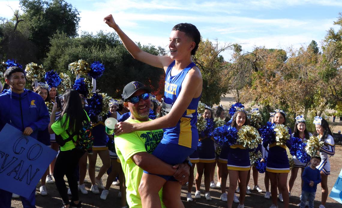 Parlier High senior Ivan Torres gets a hero’s reception after he won the Division IV title in 15:53.23 at the CIF Central Section cross country championships at Woodward Park on Nov. 16, 2023.