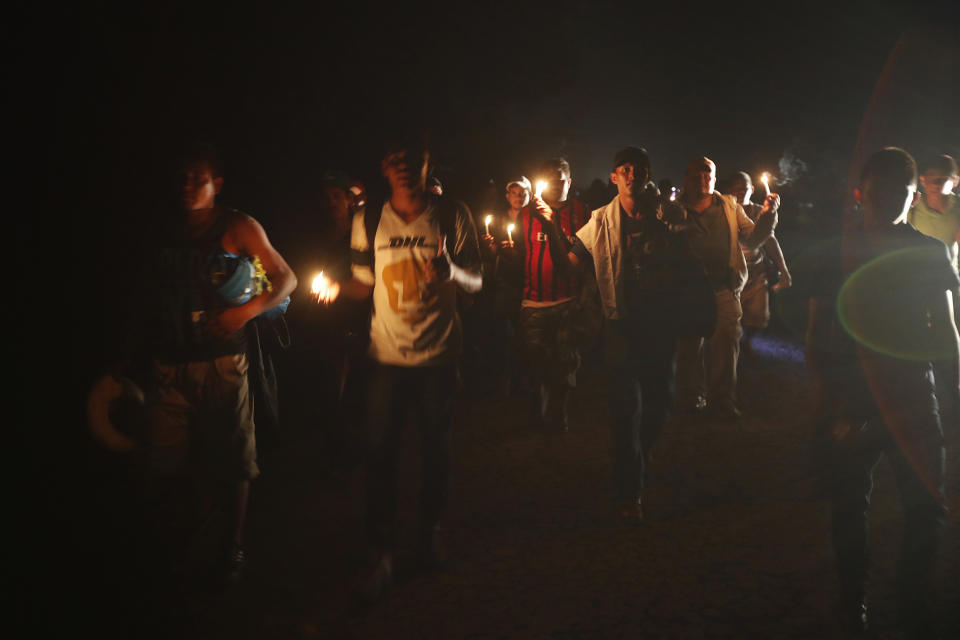 Central American migrants traveling with a caravan to the U.S. make their way to Mapastepec, Mexico, Wednesday, Oct. 24, 2018. After a day of rest to honor a fellow traveler who died on the road on Monday, the march continues through Mexico. (AP Photo/Moises Castillo)