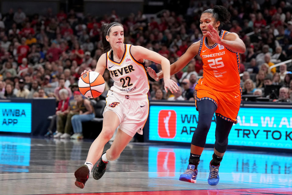 INDIANAPOLIS, INDIANA - MAY 20: Caitlin Clark #22 of the Indiana Fever drives against Alyssa Thomas #25 of the Connecticut Sun during a game at Gainbridge Fieldhouse on May 20, 2024 in Indianapolis, Indiana. NOTE TO USER: User expressly acknowledges and agrees that, by downloading and or using this photograph, User is consenting to the terms and conditions of the Getty Images License Agreement. (Photo by Emilee Chinn/Getty Images)