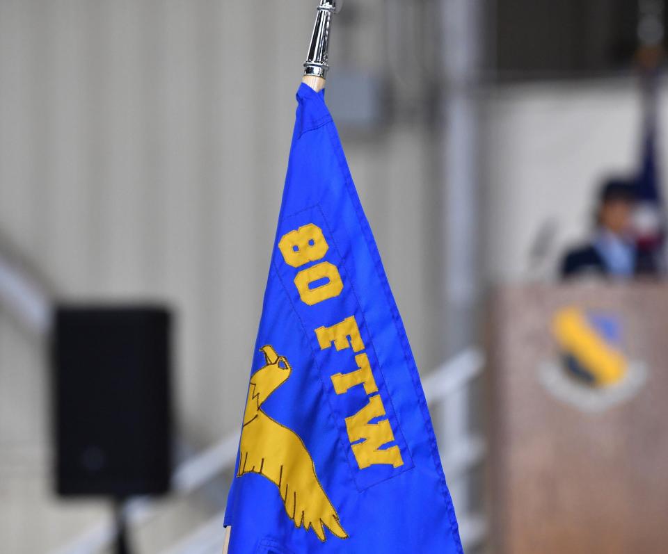 The 80th Flying Training Wing flag is held during the change of command ceremony on Wednesday at Sheppard Air Force Base.